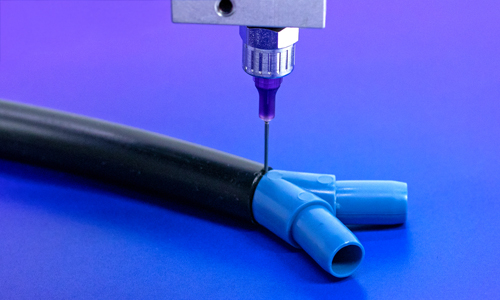 Dymax HLC adhesives are dispensed onto opaque substrates.