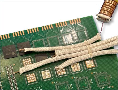 A thermocouple is attached to a printed circuit board with Dymax 9037-F adhesive.